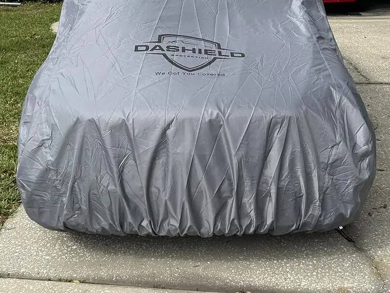 Customer photo: the elastic hem of a DaShield cover snug around a Mercedes-AMG GLC 43