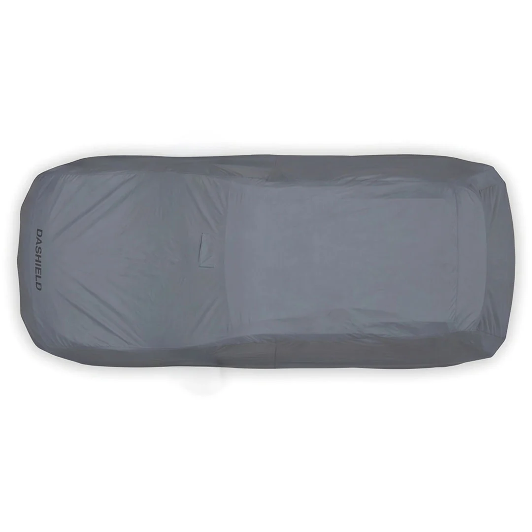 Hands pulling the elastic hem down under the front bumper