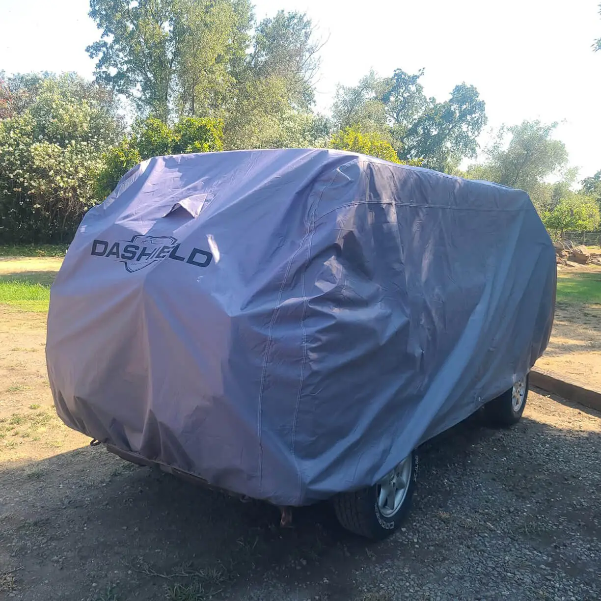 Rear three-quarter view of the same covered van showing the tailored rear hatch panel and grommet