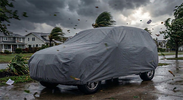 Van cover strapped down in strong wind