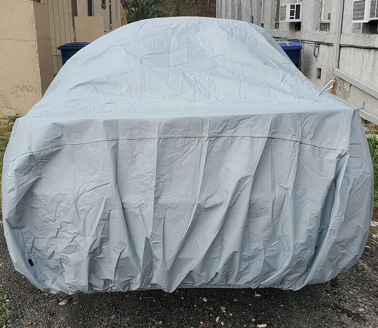 Close-up of a tailored car cover front fit