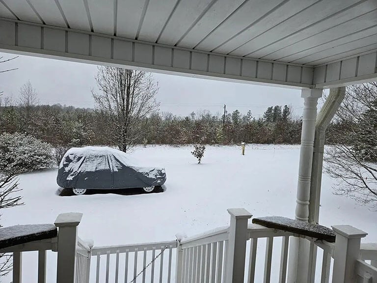 Covered car holding up under winter snow