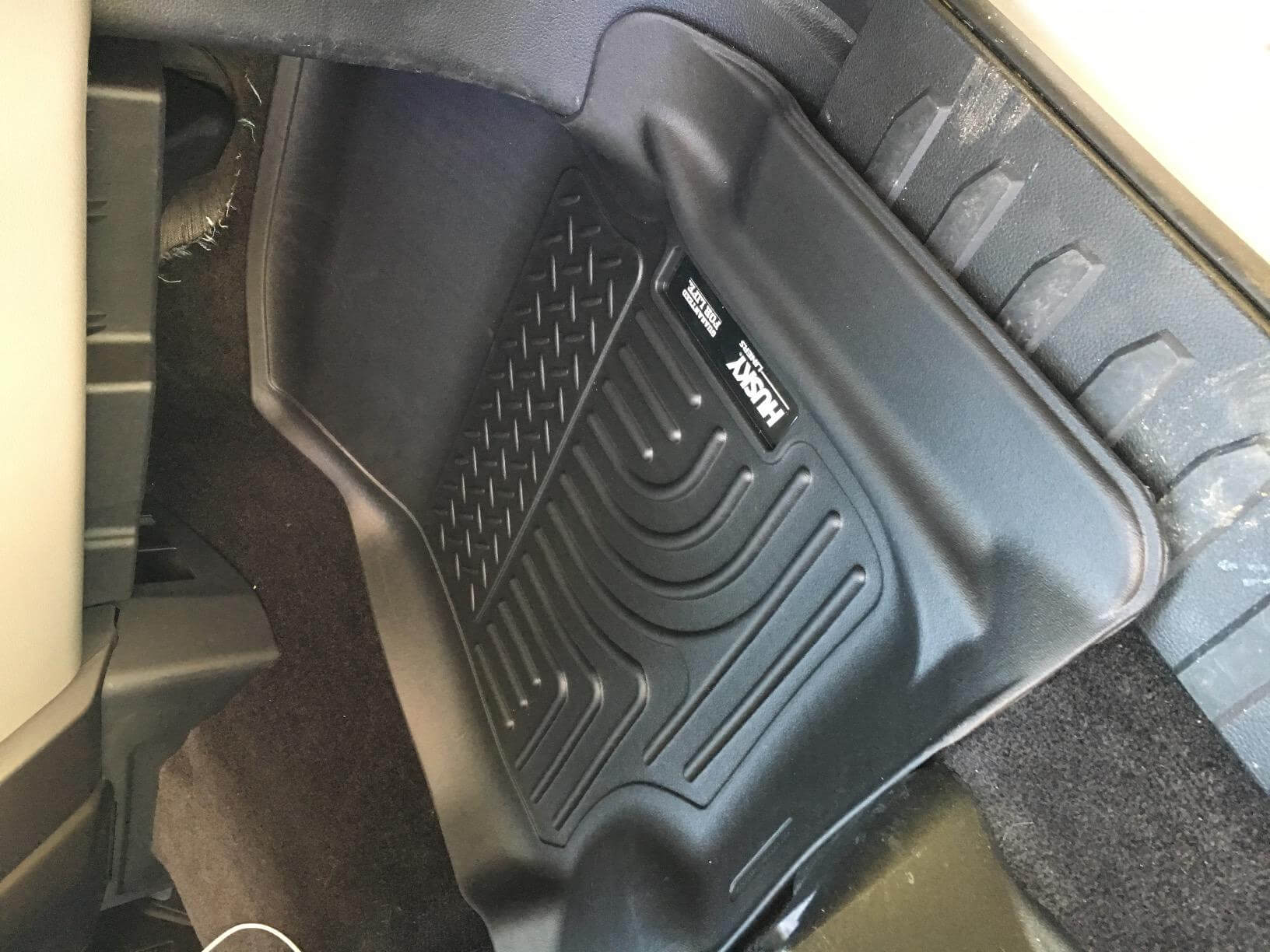 Husky mat installed in a red Ford F-150 driver footwell
