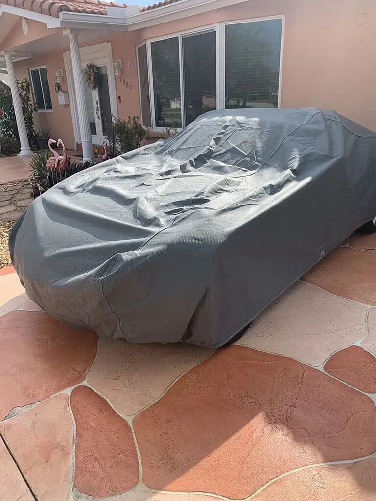 Snow-covered car cover keeping the paint protected