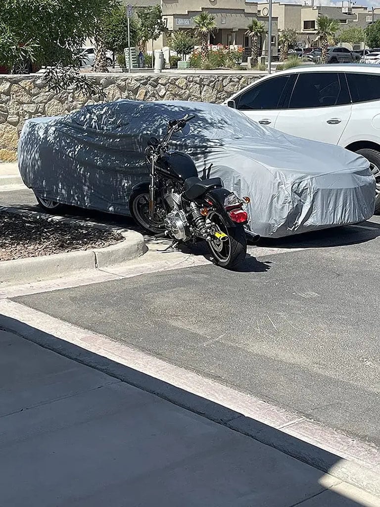 Waterproof car cover in a driveway